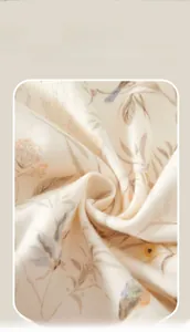 Close-up of soft cotton baby romper fabric with elegant bird and floral prints