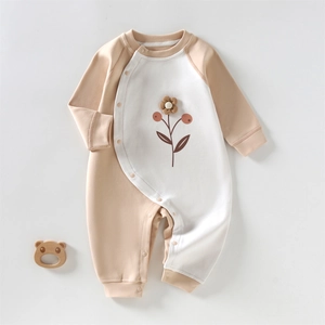 Soft cotton baby romper with color block design, long sleeves, and snap closure