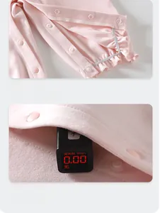 Detail of pink cotton baby bodysuit featuring safe snap buttons and ruffles with zero fluorescence