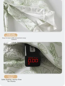 Detail of baby cotton romper showing safe fluorescence-free test and snap button closure