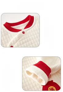 Detail of baby thermal quilted bodysuit with hemmed neckline and red embroidery