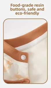 Detail of baby romper neckline featuring a safe resin button and soft cloud pattern