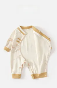 Detail of baby romper with traditional Chinese knot and delicate bamboo leaf pattern