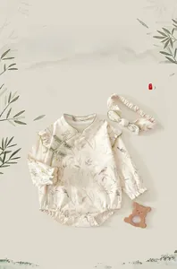 Detail of newborn baby romper with traditional Chinese frog buttons and floral pattern
