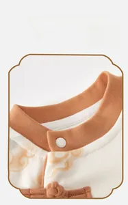 Macro shot of Mandarin collar with traditional knot buckle on baby bodysuit