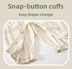 Detail view of cotton floral baby romper snap buttons for easy diaper changing
