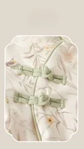 Detail of traditional Chinese frog button and floral cotton fabric on baby bodysuit