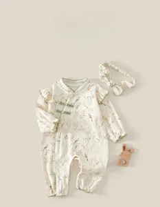 Detail of baby cotton romper with vintage floral prints, Chinese knots and accessories