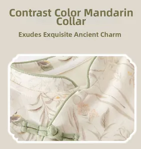 Detail view of contrast piping diagonal placket and Chinese collar on baby bodysuit