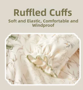 Detail of newborn cotton bodysuit with floral bird print and ruffled elastic cuffs