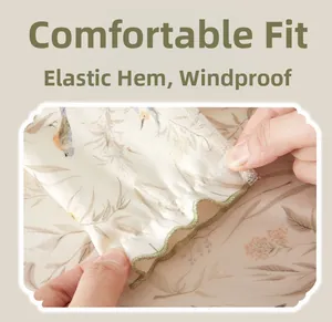 Detail of elastic ruffled cuffs on soft cotton newborn trousers with bird and leaf print