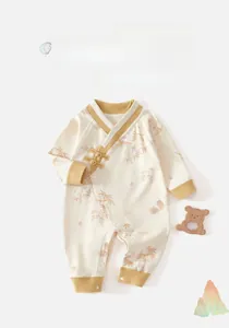 Detailed view of white cotton baby romper featuring traditional Chinese knots and bamboo prints