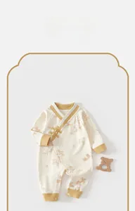 Detail of baby romper with Chinese frog buttons and elegant bamboo leaf pattern prints