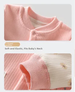 Close-up of pink knit baby bodysuit featuring a soft U-neckline and daisy print cuffs