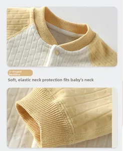 Detail view of U-shaped neckline with ribbed edges and snap buttons on warm baby romper