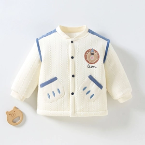 Détail de la broderie lion et bordure marine sur le cardigan matelassé beige bébé