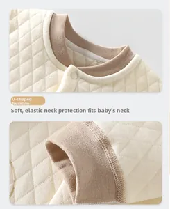 Detail of baby thermal romper showing the U-neck design and elastic cuffs with quilted texture