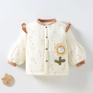 Detail view of baby girl's quilted cardigan with sunflower embroidery and bear patch