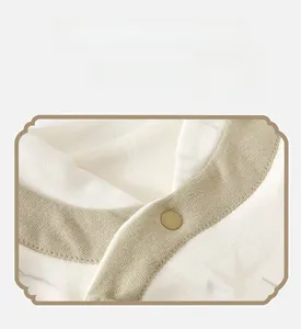 Detail of baby vest with Chinese style diagonal collar and green contrast piping