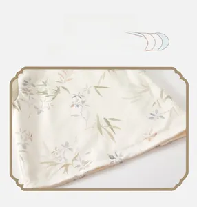 Detailed view of baby vest hem featuring floral print on beige cotton fabric