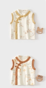 Detailed view of Chinese style baby vests with bamboo and cloud patterns and frog buttons