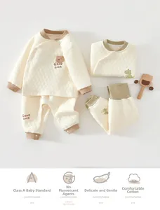 Detail of baby quilted cotton pajama set with cute bear patches and soft rib knit cuffs