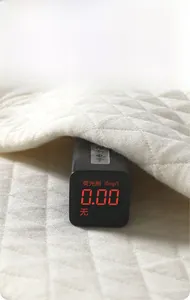 Close-up of quilted baby romper fabric with a digital detector showing zero fluorescence