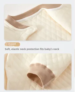 Detail of baby thermal quilted fabric with U-shaped neckline and snap button closures