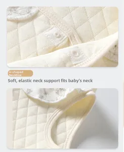 Detail of warm quilted infant vest with U-shaped neckline and floral trim borders