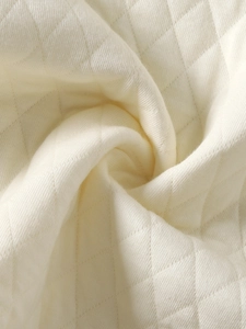 Quilted warm knit infant vest in cream white with diamond stitching for autumn