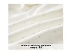 Detail of boneless stitching on cotton newborn bodysuit with green leaf pattern