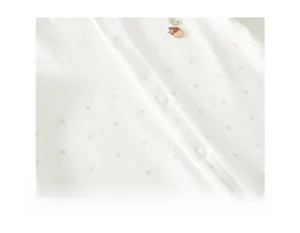 Detail of soft organic cotton fabric with safe resin buttons and leaf embroidery
