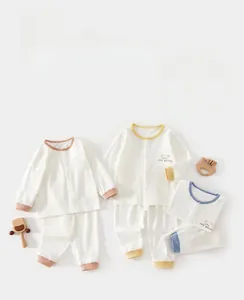Flat lay of baby long sleeve pajama sets in waffle cotton with bear embroidery