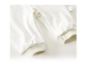 Detail of snap button closures on newborn baby romper with star prints and ribbed cuffs