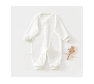 Detail of newborn cotton bodysuit with delicate star prints and green ribbed cuffs