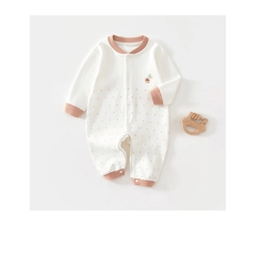 Detail of newborn cotton romper with acorn embroidery and snap buttons closure