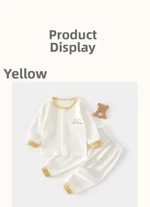 Detail of baby cotton pajama set with yellow ribbed edges and a cartoon bear graphic