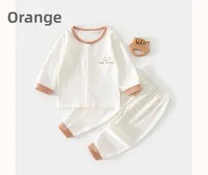 Detail of baby waffle knit loungewear set with orange ribbed cuffs and bear print