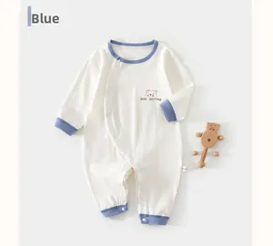 Detail showing soft cotton waffle fabric and blue embroidered bear on baby romper