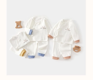 Close-up of baby waffle cotton long-sleeve pajamas with bear brother embroidery and side ties