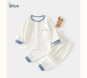 Detailed close-up of baby waffle cotton sleepwear featuring blue contrast trim and bear print