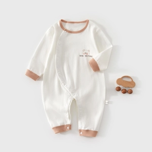 Infant long sleeve romper in beige waffle fabric featuring a cartoon bear print