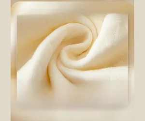 Macro detail of cream knit fabric with diamond pattern for baby thermal bodysuits