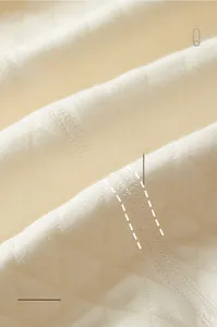 Close-up of baby romper with soft quilted diamond texture and flat seamless stitching