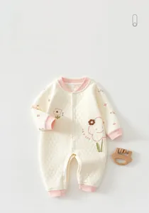 Detail of baby quilted romper with pink ribbed cuffs and Lucky floral embroidery