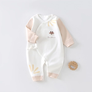 Detail view of cotton newborn romper featuring deer embroidery and Christmas print