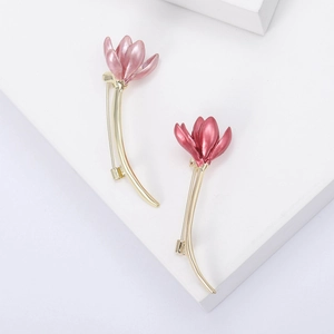 Elegant enamel magnolia flower brooch in pink and rose red with gold stems