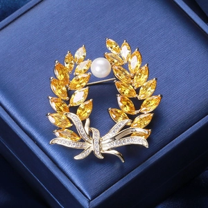Golden wheat ear brooch with yellow zircons, round white pearl, and elegant bow decoration