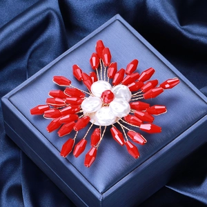 Handmade red crystal bead flower brooch with white pearls and gold wire on navy velvet
