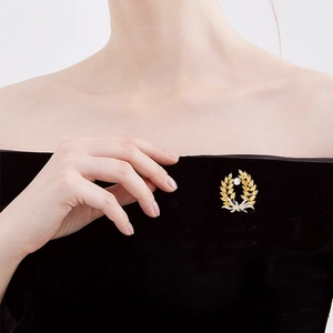 Elegant gold wheat brooch with amber zircons and white pearl on black formal dress